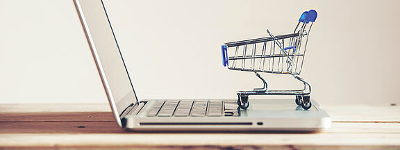 Laptop with a small shopping trolley