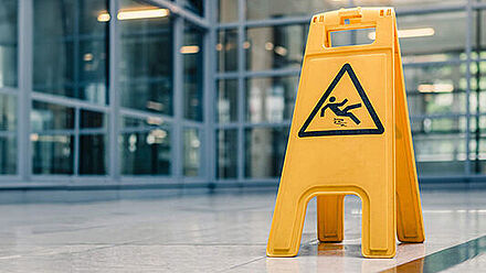 RENOLIT_yellow sign on floor that alerts for wet floor